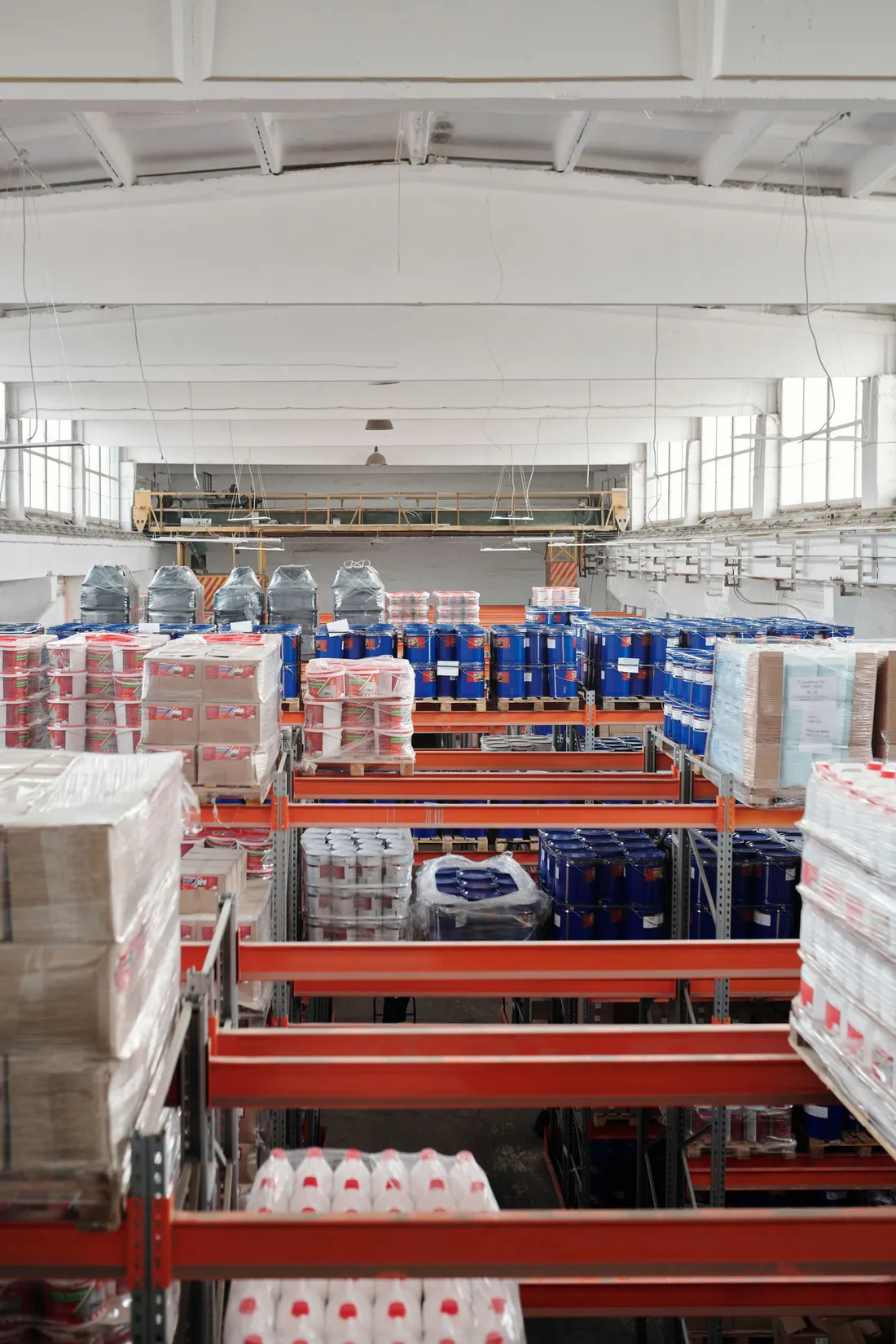 Tall cold storage warehouse aisle with racked shelving